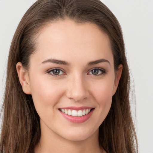 Joyful white young-adult female with long  brown hair and grey eyes