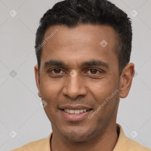 Joyful latino young-adult male with short  brown hair and brown eyes