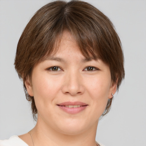 Joyful white adult female with medium  brown hair and brown eyes