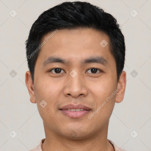 Joyful asian young-adult male with short  black hair and brown eyes