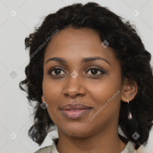 Joyful black young-adult female with long  black hair and brown eyes