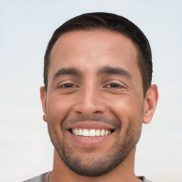 Joyful white young-adult male with short  black hair and brown eyes