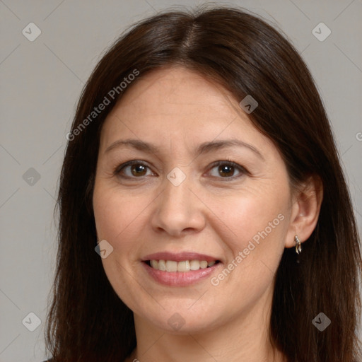 Joyful white adult female with long  brown hair and brown eyes