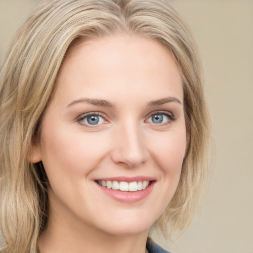 Joyful white young-adult female with medium  blond hair and blue eyes