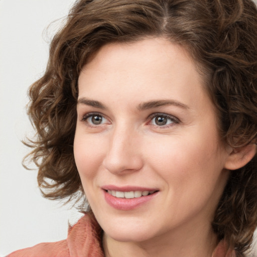 Joyful white young-adult female with medium  brown hair and green eyes