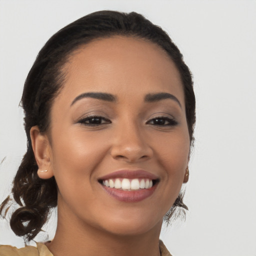 Joyful latino young-adult female with medium  brown hair and brown eyes