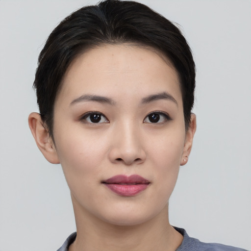 Joyful asian young-adult female with short  black hair and brown eyes