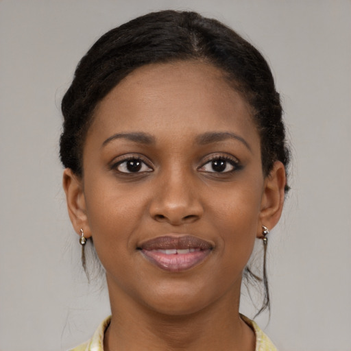 Joyful black young-adult female with medium  brown hair and brown eyes
