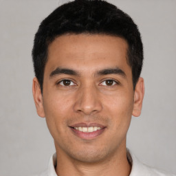 Joyful white young-adult male with short  black hair and brown eyes