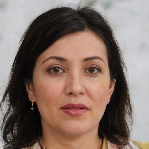 Joyful white adult female with medium  brown hair and brown eyes
