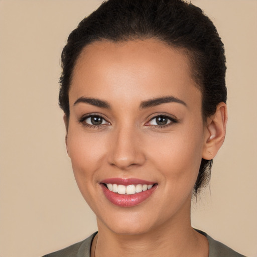 Joyful white young-adult female with long  black hair and brown eyes