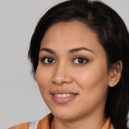 Joyful latino young-adult female with medium  brown hair and brown eyes