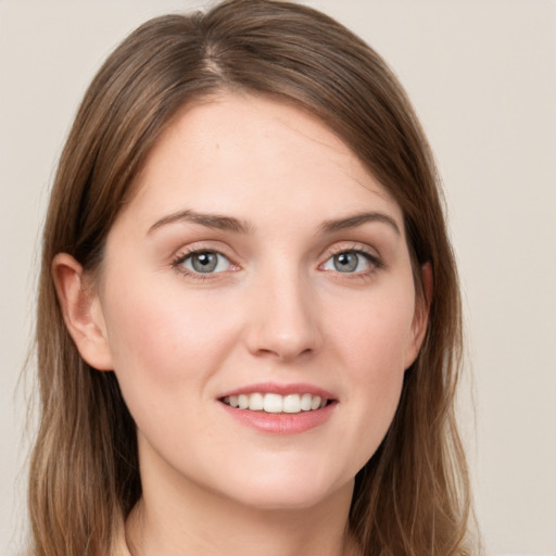 Joyful white young-adult female with long  brown hair and grey eyes