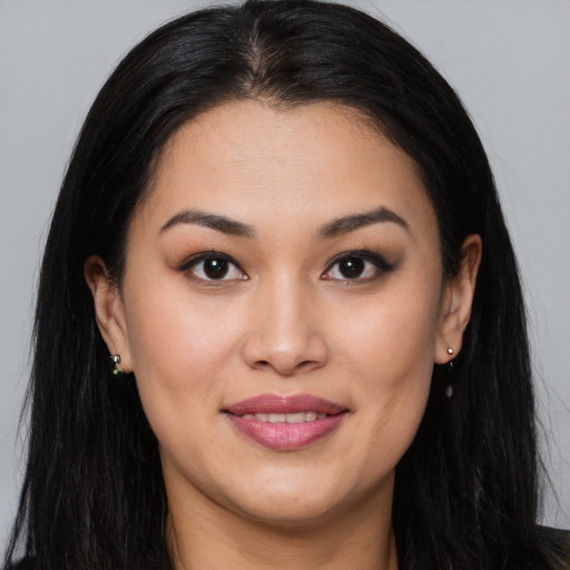 Joyful asian young-adult female with long  brown hair and brown eyes