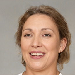 Joyful white adult female with medium  brown hair and brown eyes