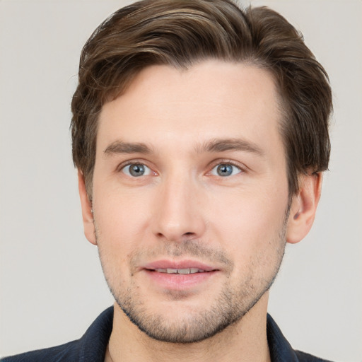 Joyful white young-adult male with short  brown hair and grey eyes