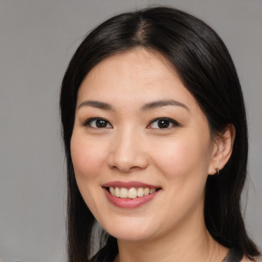 Joyful asian young-adult female with medium  brown hair and brown eyes