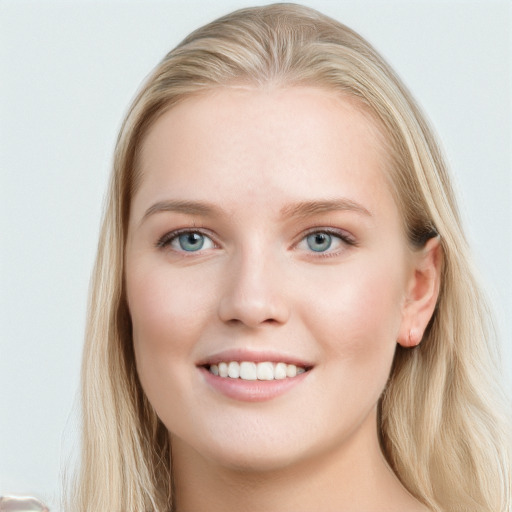 Joyful white young-adult female with long  brown hair and blue eyes