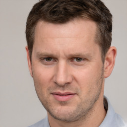 Joyful white adult male with short  brown hair and brown eyes