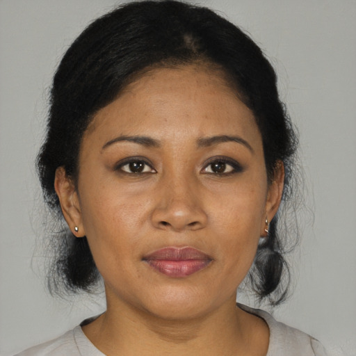 Joyful black adult female with medium  black hair and brown eyes