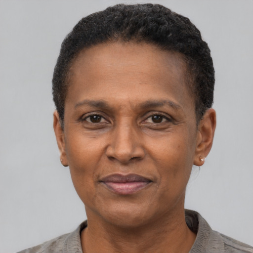 Joyful black adult female with short  black hair and brown eyes