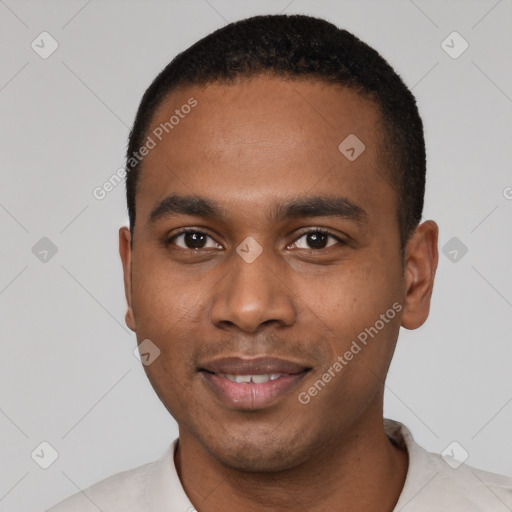 Joyful black young-adult male with short  black hair and brown eyes