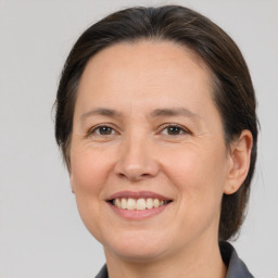 Joyful white adult female with medium  brown hair and brown eyes