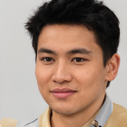 Joyful latino young-adult male with short  brown hair and brown eyes