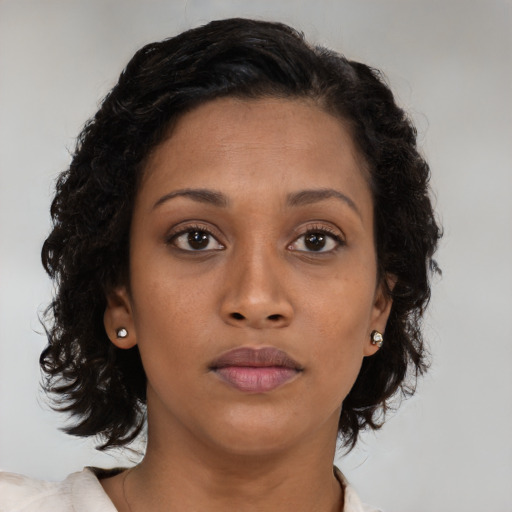 Neutral black young-adult female with medium  brown hair and brown eyes