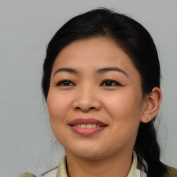 Joyful asian young-adult female with medium  brown hair and brown eyes