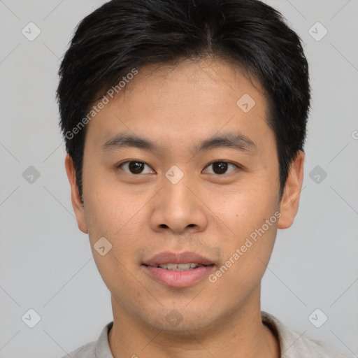 Joyful asian young-adult male with short  black hair and brown eyes