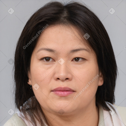 Joyful asian adult female with medium  brown hair and brown eyes