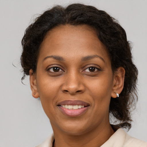 Joyful black adult female with short  brown hair and brown eyes