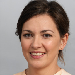 Joyful white young-adult female with medium  brown hair and brown eyes