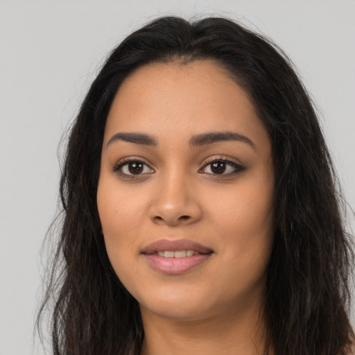 Joyful latino young-adult female with long  brown hair and brown eyes