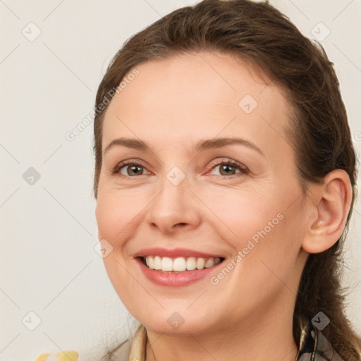 Joyful white young-adult female with long  brown hair and brown eyes