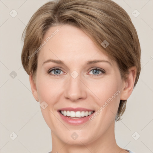 Joyful white young-adult female with short  brown hair and grey eyes