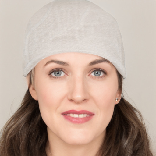 Joyful white young-adult female with long  brown hair and grey eyes