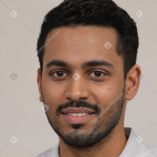 Joyful latino young-adult male with short  black hair and brown eyes