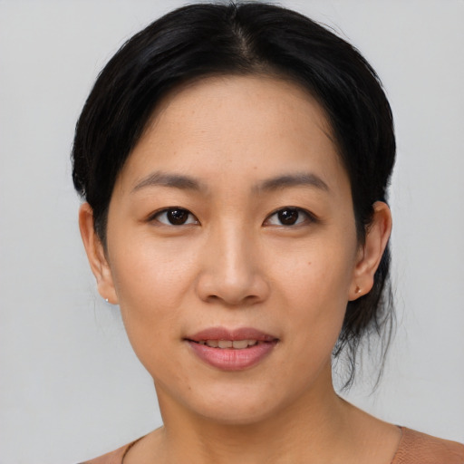 Joyful asian young-adult female with short  black hair and brown eyes