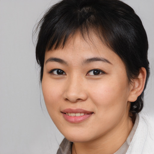 Joyful asian young-adult female with medium  brown hair and brown eyes
