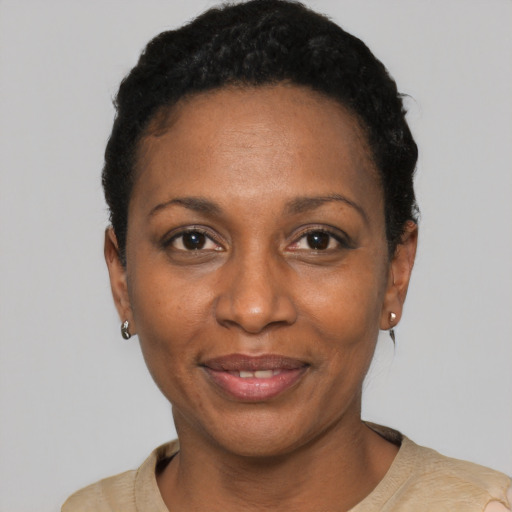 Joyful black adult female with short  black hair and brown eyes