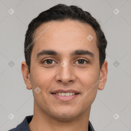 Joyful white young-adult male with short  black hair and brown eyes