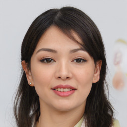 Joyful asian young-adult female with long  brown hair and brown eyes