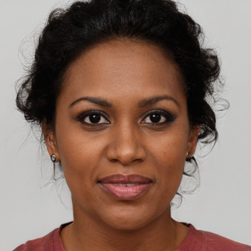 Joyful black young-adult female with medium  brown hair and brown eyes