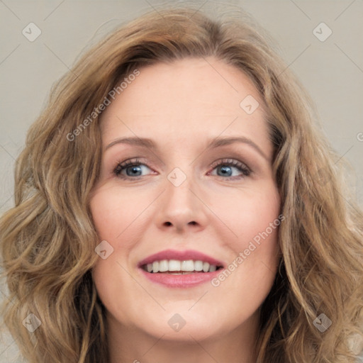 Joyful white adult female with long  brown hair and green eyes