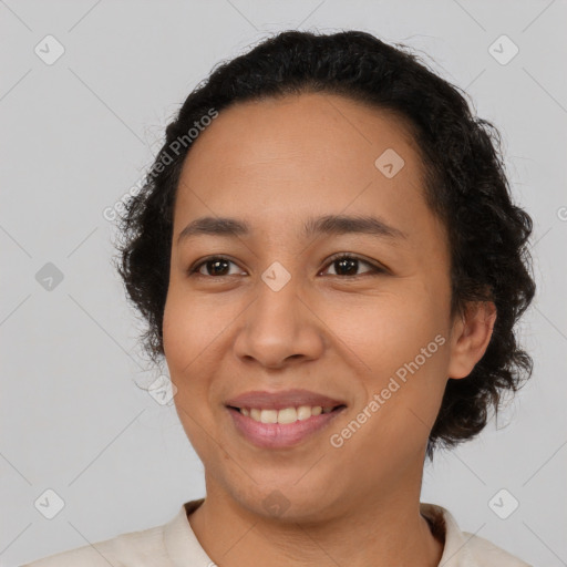 Joyful latino young-adult female with short  black hair and brown eyes