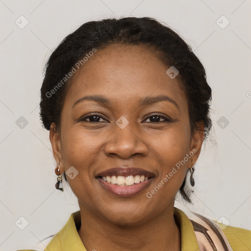 Joyful black young-adult female with short  brown hair and brown eyes