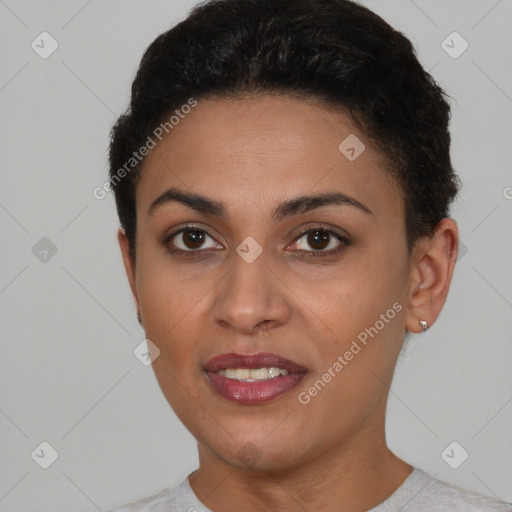 Joyful black young-adult female with short  brown hair and brown eyes