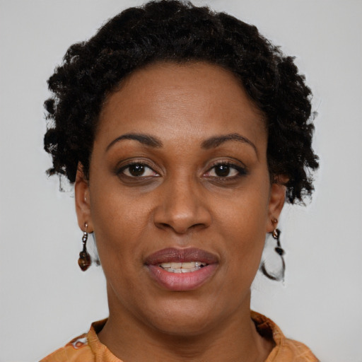 Joyful black adult female with short  brown hair and brown eyes